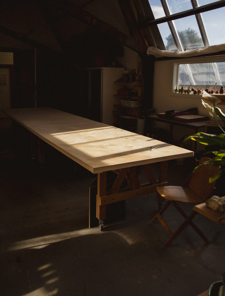 A table in the studio bathed in light